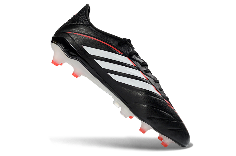 Adidas Copa Pure IV Elite FG football in action with player kicking the ball on a grass field